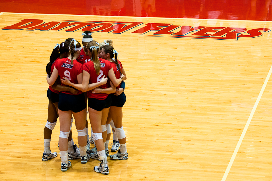 The red team huddles together before a point during the annual Red-Blue scrimmage, Aug. 18, 2012, in the Frericks Center.