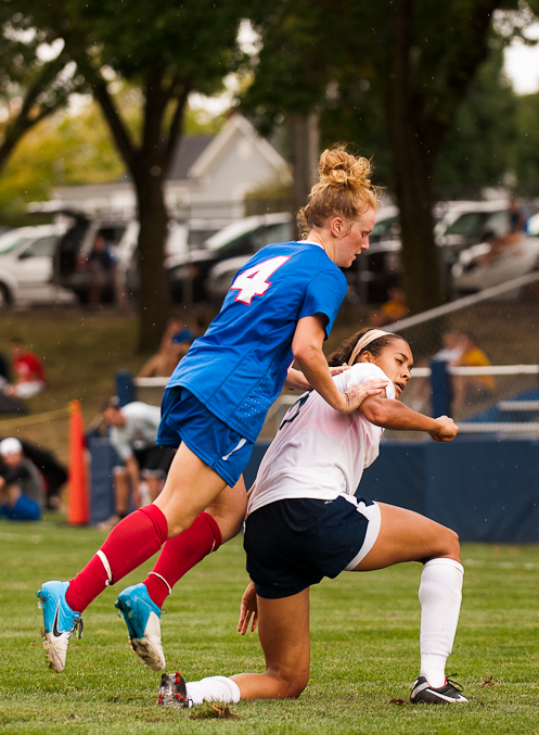 Freshman midfielder Ashley Campbell (8) is pushed down by a Blue Demon defender during a game between the University of Dayton and DePaul University, Sept. 2, 2012, at the Baujan Field, in Dayton, Ohio. DePaul won 2-1 in overtime.